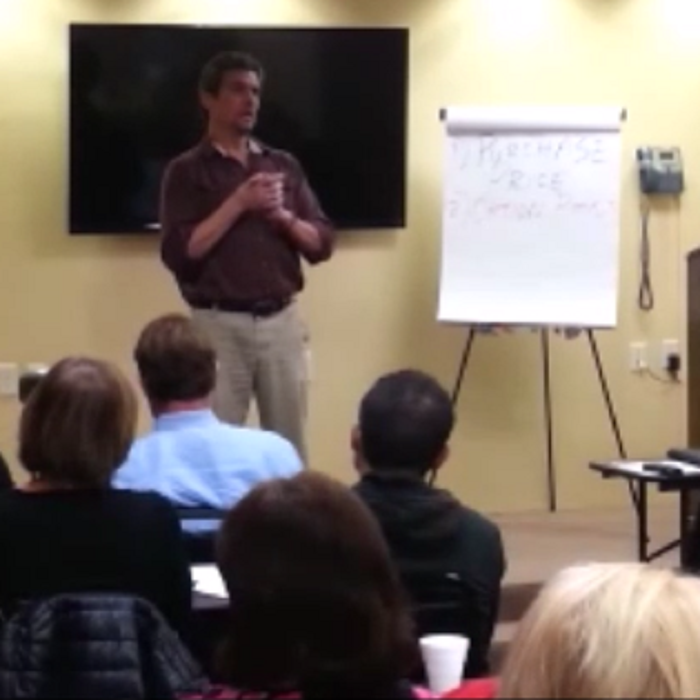 Kevin A Dunlap speaking in front of real estate investors.